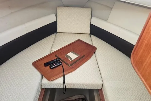 Slide: The Image of Interior cabin of 2017 Ranger Tugs R-27 with seating and a wooden tray. - 6