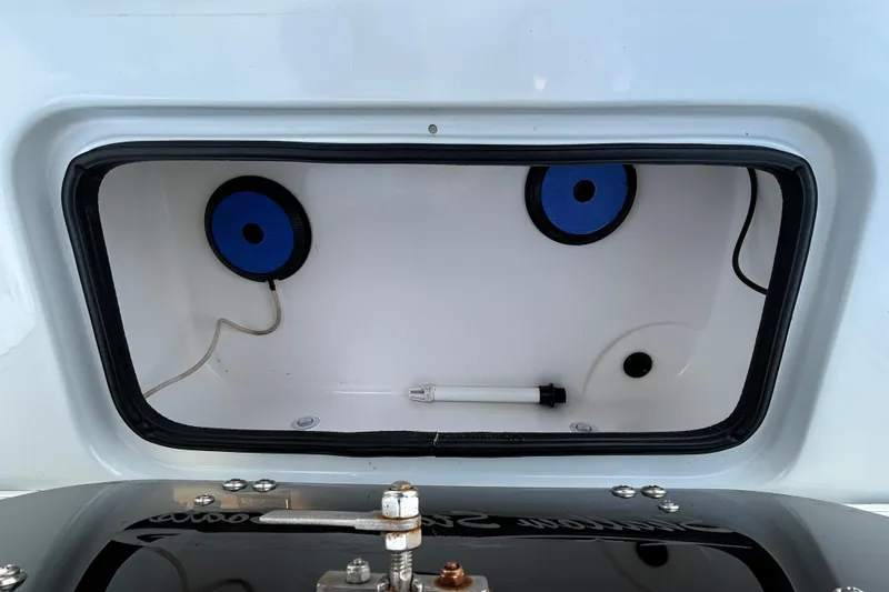 Slide: The Image of 2023 Shallow Stalker Cat 240 Elite storage compartment with blue circular components. - 11