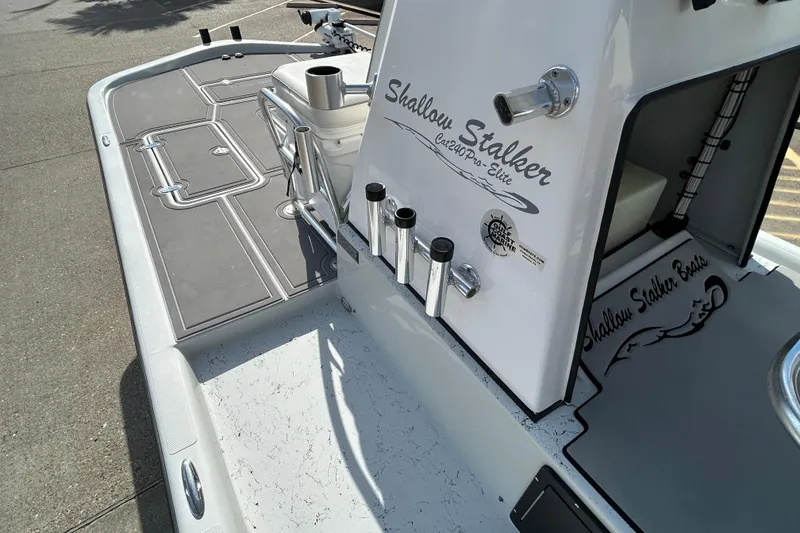 Slide: The Image of 2023 Shallow Stalker Cat 240 Elite boat deck with rod holders and sleek design. - 15