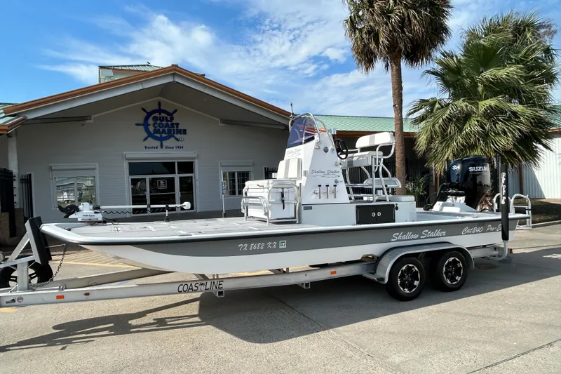 Slide: The Image of 2023 Shallow Stalker Cat 240 Elite boat on trailer outside Gulf Coast Marine. - 2