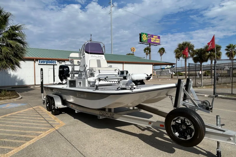 Slide: The Image of 2023 Shallow Stalker Cat 240 Elite boat on trailer, parked outdoors. - 4