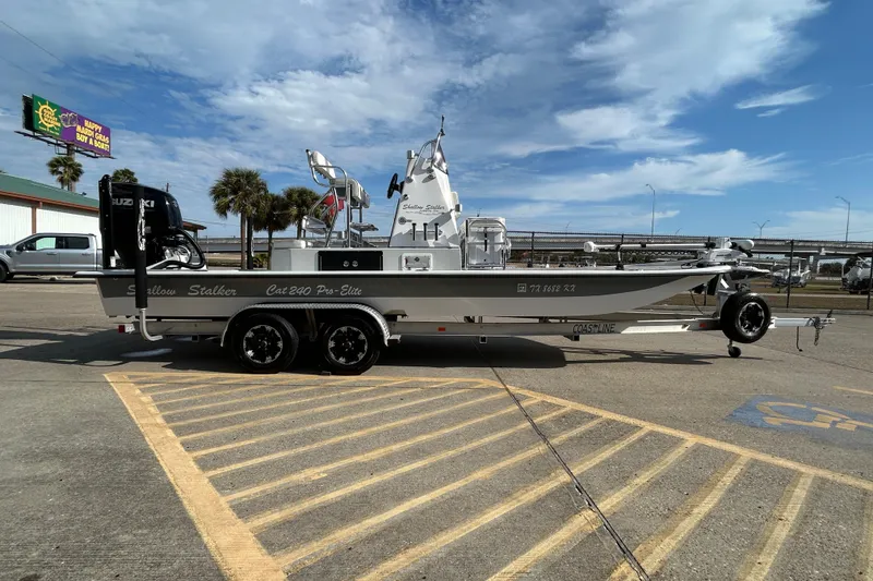Slide: The Image of 2023 Shallow Stalker Cat 240 Elite boat on trailer, parked in sunny lot. - 5