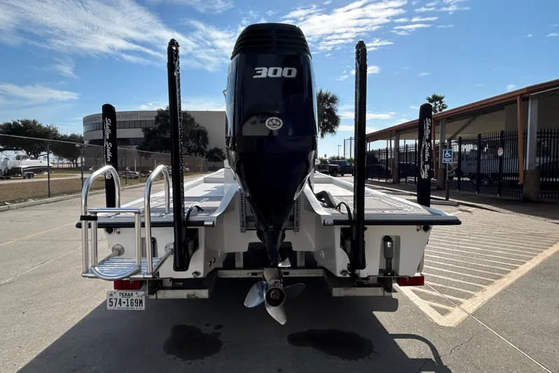 Slide: The Image of 2023 Shallow Stalker Cat 240 Elite boat with powerful 300 HP engine, parked outdoors. - 7