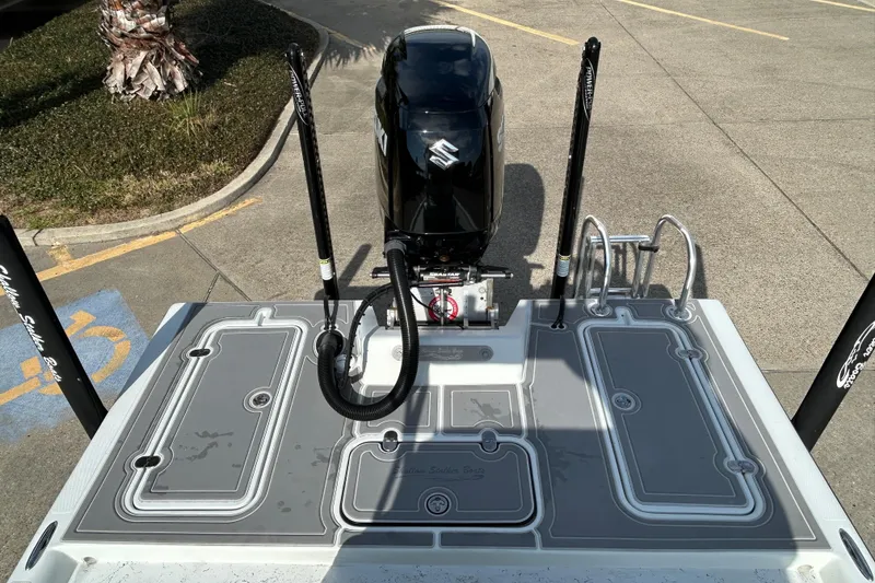 Slide: The Image of 2023 Shallow Stalker Cat 240 Elite boat with Suzuki outboard motor in parking lot. - 8