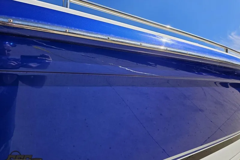 Slide: The Image of 2009 Formula 353 FASTech boat with blue hull and visible surface crack. - 14