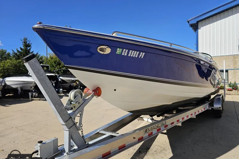 Slide: The Image of 2009 Formula 353 FASTech boat on trailer, blue and white, parked outdoors. - 19