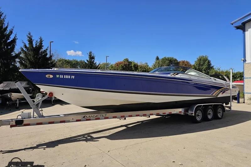 Slide: The Image of 2009 Formula 353 FASTech boat on trailer, blue and white design, parked outdoors. - 20