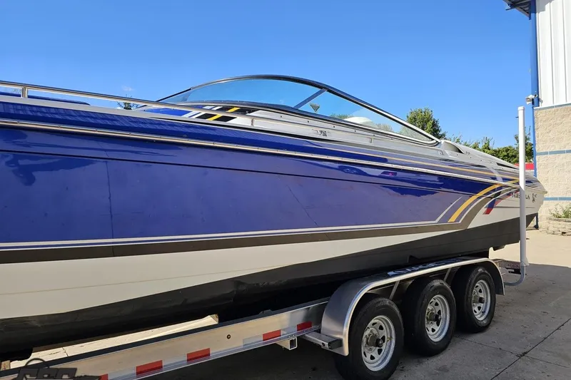 Slide: The Image of 2009 Formula 353 FASTech boat on trailer, blue and white design, sunny day. - 21