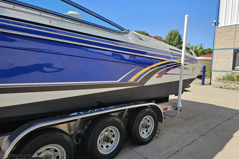 Slide: The Image of 2009 Formula 353 FASTech boat on trailer, blue and white design, parked outdoors. - 22