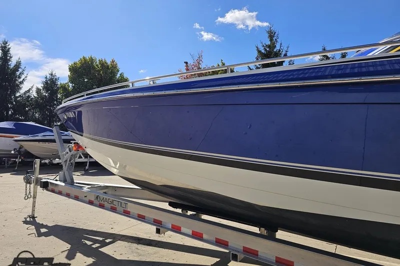 Slide: The Image of 2009 Formula 353 FASTech boat on trailer under clear blue sky. - 23