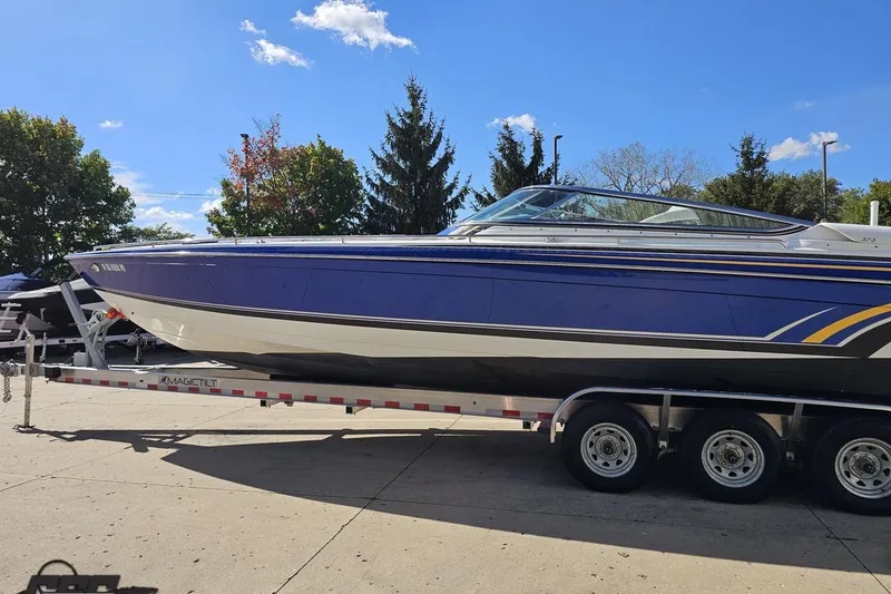 Slide: The Image of 2009 Formula 353 FASTech boat on trailer under clear blue sky. - 24
