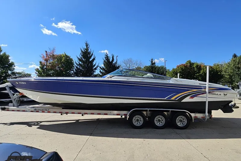 Slide: The Image of 2009 Formula 353 FASTech boat on trailer under clear blue sky. - 25