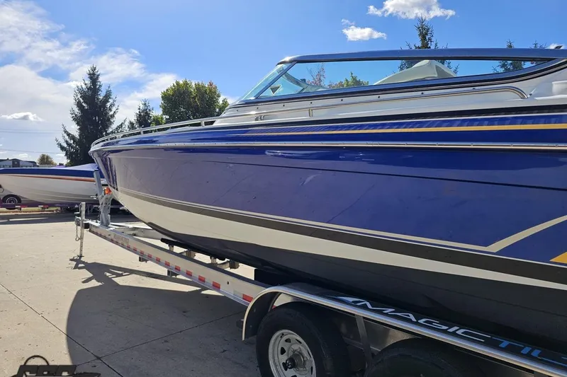 Slide: The Image of 2009 Formula 353 FASTech boat on trailer, blue and white design, parked outdoors. - 27