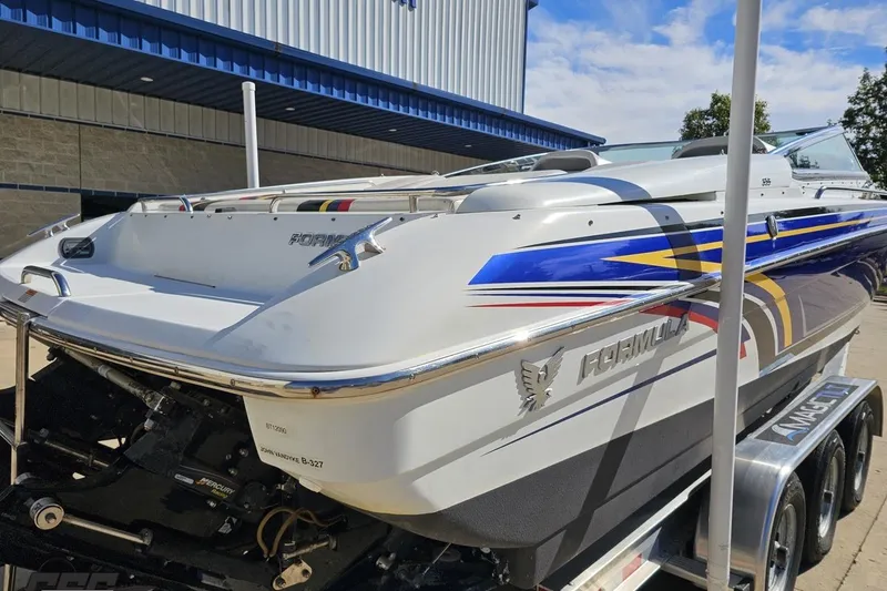 Slide: The Image of 2009 Formula 353 FASTech boat with vibrant graphics on a trailer. - 34