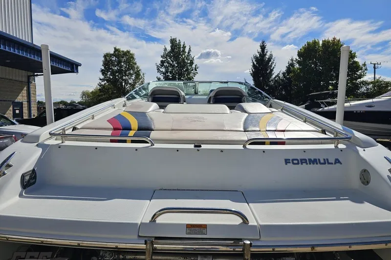Slide: The Image of 2009 Formula 353 FASTech boat, rear view, with colorful seating and clear sky background. - 35