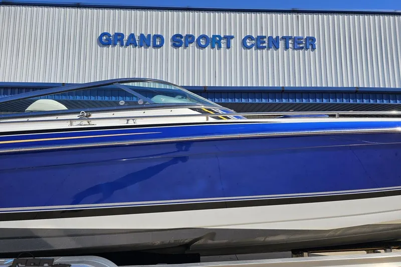 Slide: The Image of 2009 Formula 353 FASTech boat at Grand Sport Center, blue and white exterior. - 4