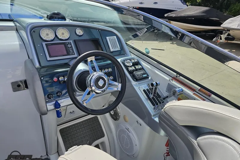 Slide: The Image of 2009 Formula 353 FASTech boat cockpit with steering wheel and control panel. - 52