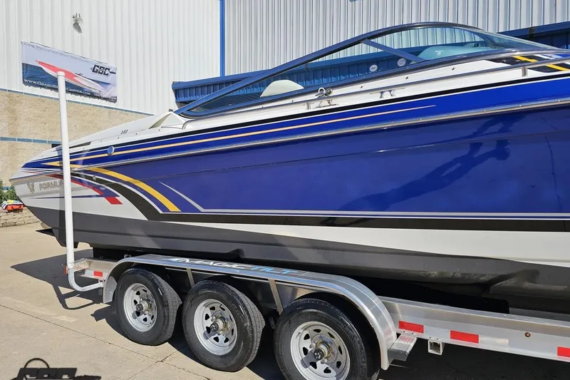 Slide: The Image of 2009 Formula 353 FASTech boat on trailer, featuring sleek blue and white design. - 6