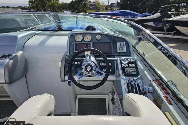 Slide: The Image of 2009 Formula 353 FASTech boat cockpit with steering wheel and control panel. - 63