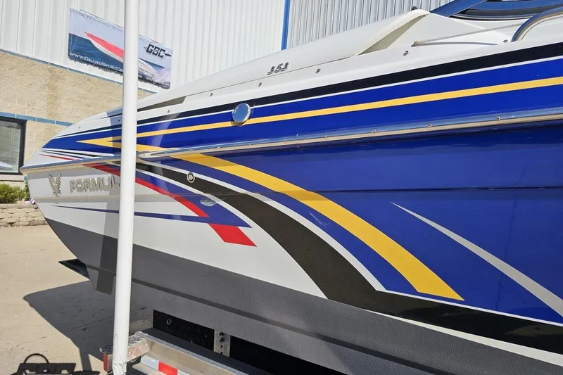 Slide: The Image of 2009 Formula 353 FASTech boat with vibrant blue, yellow, and red graphics on the side. - 7