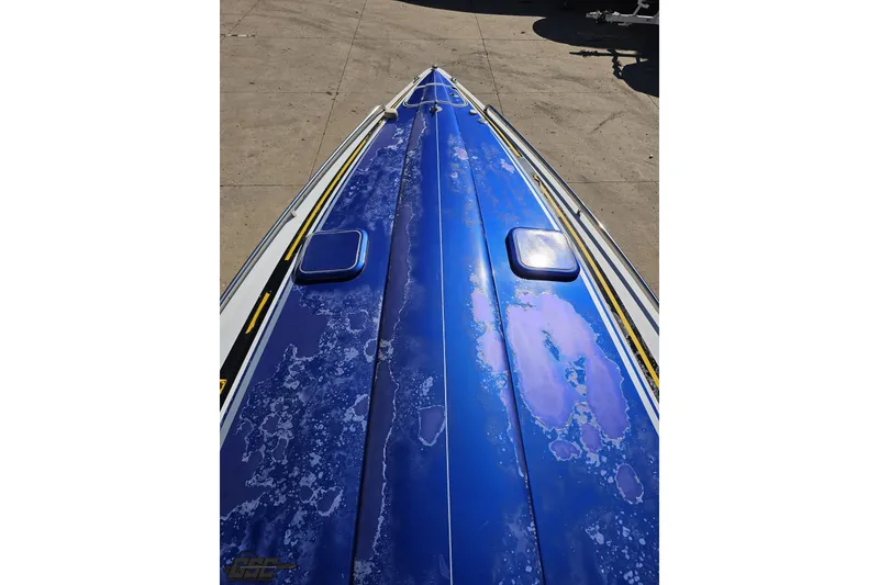 Slide: The Image of 2009 Formula 353 FASTech boat with weathered blue hull on display. - 72