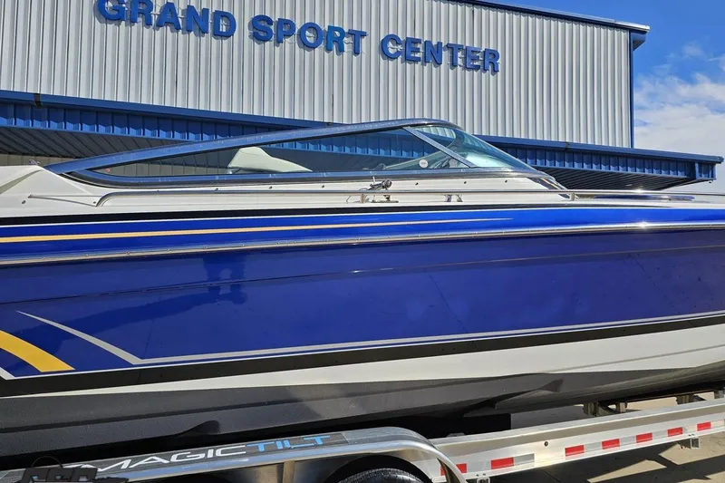 Slide: The Image of 2009 Formula 353 FASTech boat at Grand Sport Center, blue and white design. - 8