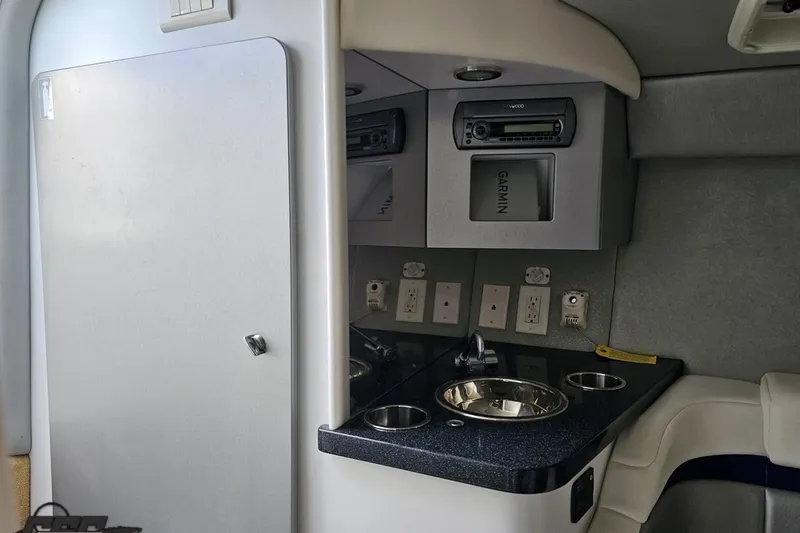 Slide: The Image of 2009 Formula 353 FASTech cabin interior with sink, outlets, and Garmin equipment. - 80