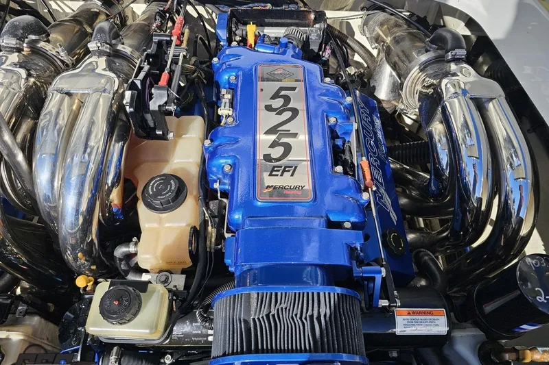 Slide: The Image of 2009 Formula 353 FASTech engine with Mercury 525 EFI, featuring chrome exhaust headers. - 99
