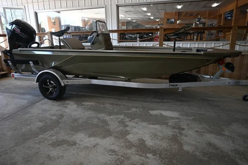 The Image of 2026 Thor 1900 boat on trailer in showroom, featuring sleek design and modern outboard motor. - 0