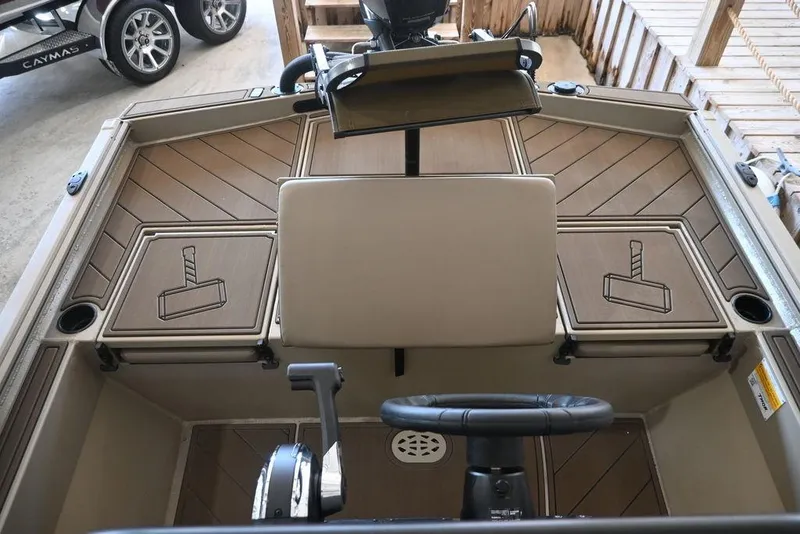 Slide: The Image of 2026 Thor 1900 boat interior with steering wheel and hammer design accents. - 11