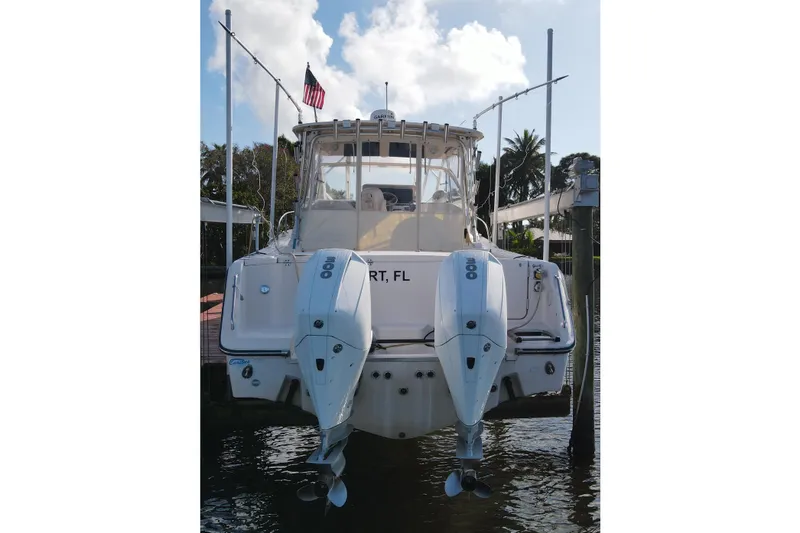 Slide: The Image of 2010 Grady-White Express 330 boat with dual outboard engines docked in Florida. - 11