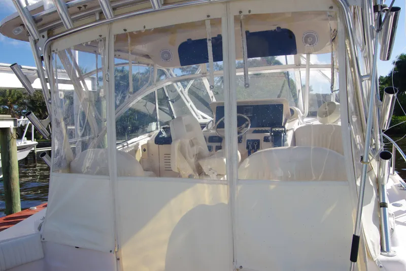 Slide: The Image of 2010 Grady-White Express 330 boat interior with clear enclosure and steering wheel. - 12