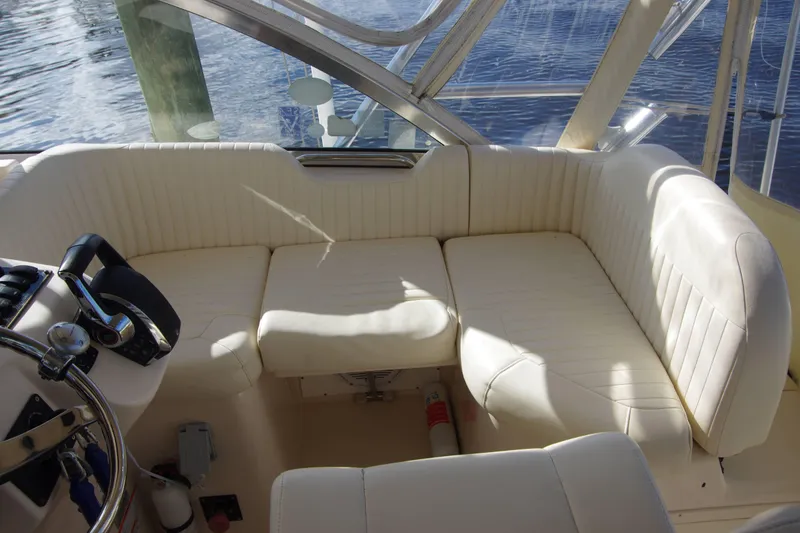 Slide: The Image of Interior of 2010 Grady-White Express 330 boat with white seating and steering wheel. - 18