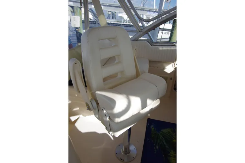 Slide: The Image of Captain's chair on 2010 Grady-White Express 330 boat, featuring white upholstery and sturdy design. - 19
