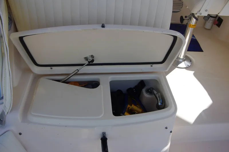 Slide: The Image of Storage compartment on a 2010 Grady-White Express 330 boat, open with items inside. - 20