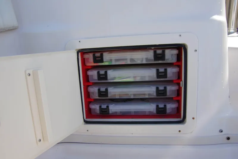 Slide: The Image of Storage compartment with tackle boxes on a 2010 Grady-White Express 330 boat. - 21