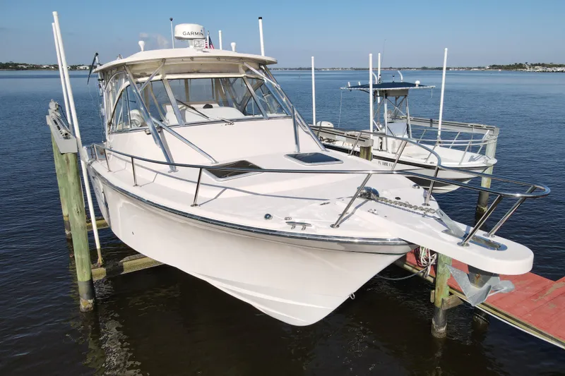 Slide: The Image of 2010 Grady-White Express 330 boat docked on calm water. - 3