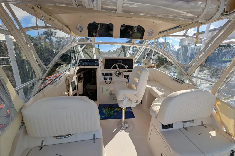 Slide: The Image of 2010 Grady-White Express 330 boat interior with helm, seating, and clear canopy. - 30