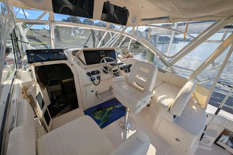 Slide: The Image of 2010 Grady-White Express 330 boat interior with helm, seating, and water view. - 33