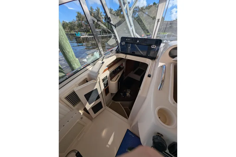 Slide: The Image of 2010 Grady-White Express 330 boat interior with open cabin door, dockside view. - 36