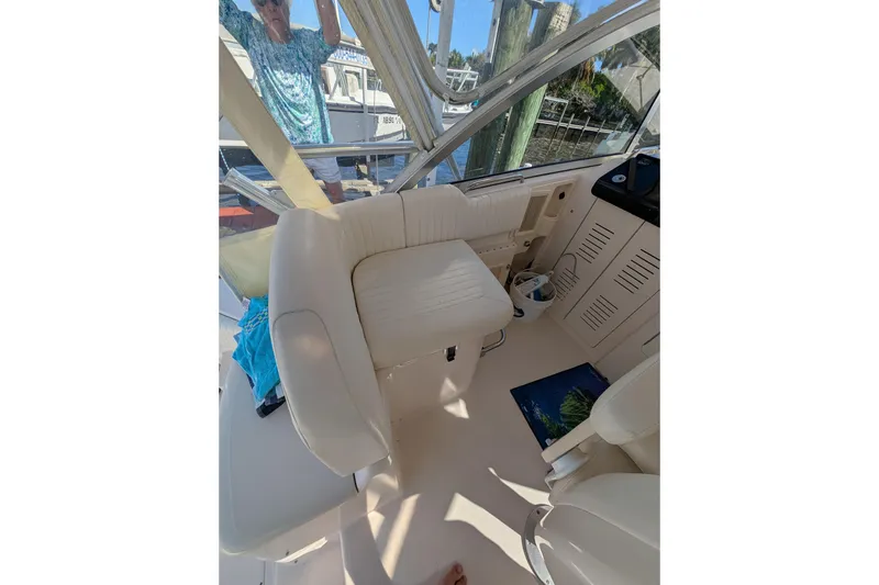 Slide: The Image of 2010 Grady-White Express 330 boat interior with white seating and helm area. - 37