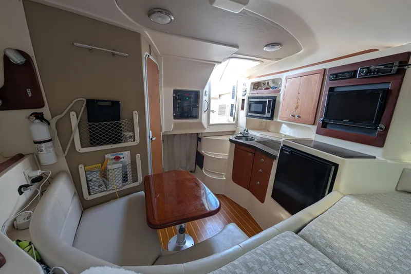 Slide: The Image of Interior of 2010 Grady-White Express 330 boat with kitchenette and seating area. - 42