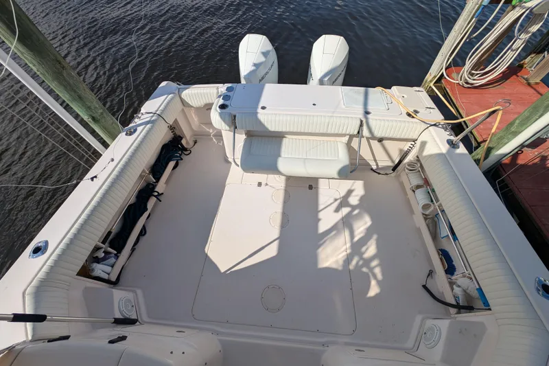 Slide: The Image of 2010 Grady-White Express 330 boat deck with seating and twin outboard motors. - 45
