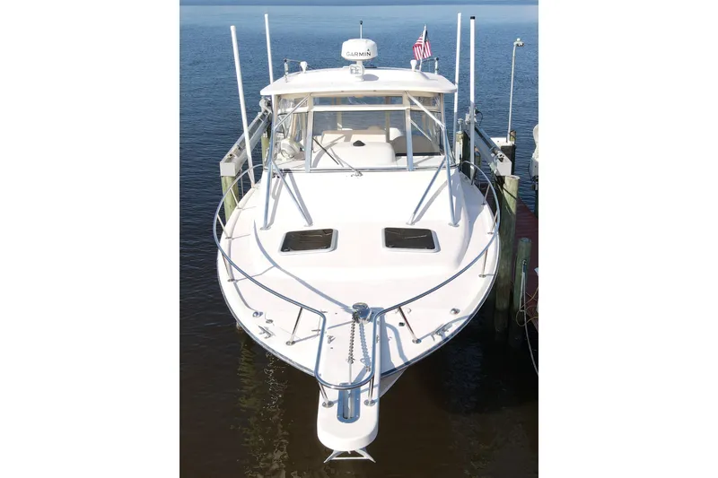 Slide: The Image of 2010 Grady-White Express 330 boat docked, front view, with American flag. - 5