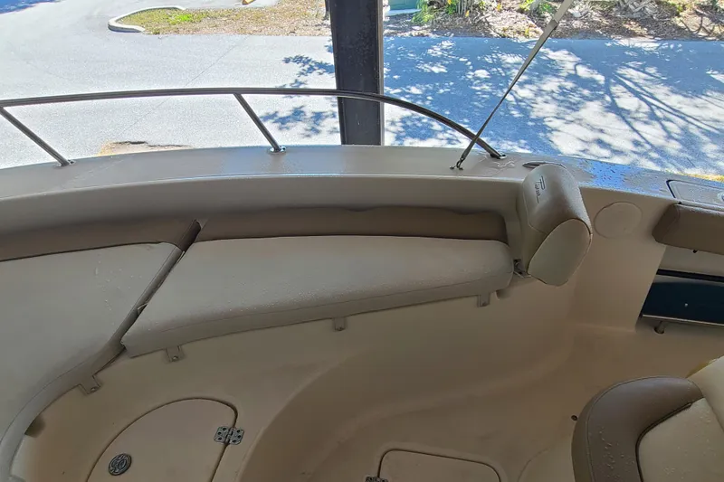 Slide: The Image of 2015 Pioneer 220 Bay Sport boat interior with cushioned seating and railing. - 11