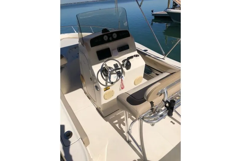 Slide: The Image of 2015 Pioneer 220 Bay Sport boat interior with steering console and seating. - 14