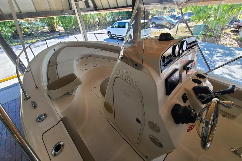 Slide: The Image of 2015 Pioneer 220 Bay Sport boat interior with steering console and seating. - 15