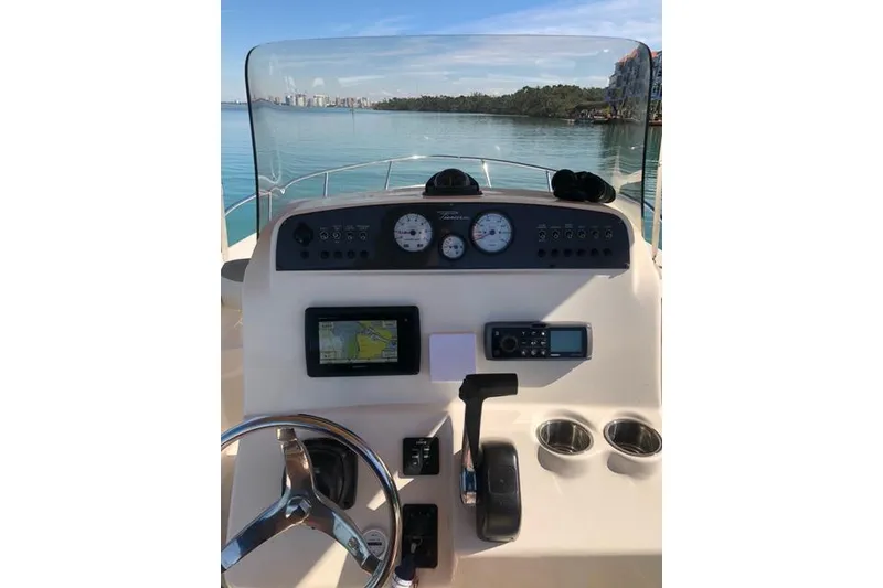 Slide: The Image of 2015 Pioneer 220 Bay Sport boat dashboard with steering wheel and navigation instruments. - 16