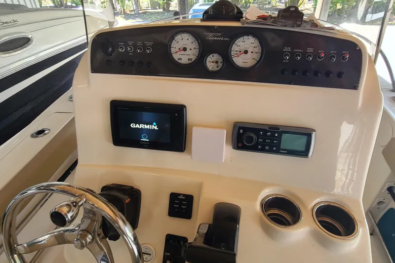 Slide: The Image of 2015 Pioneer 220 Bay Sport boat dashboard with Garmin display and control panel. - 17