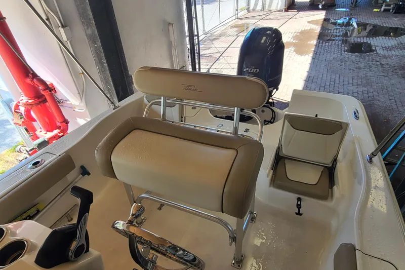 Slide: The Image of 2015 Pioneer 220 Bay Sport boat interior with seating and motor. - 23